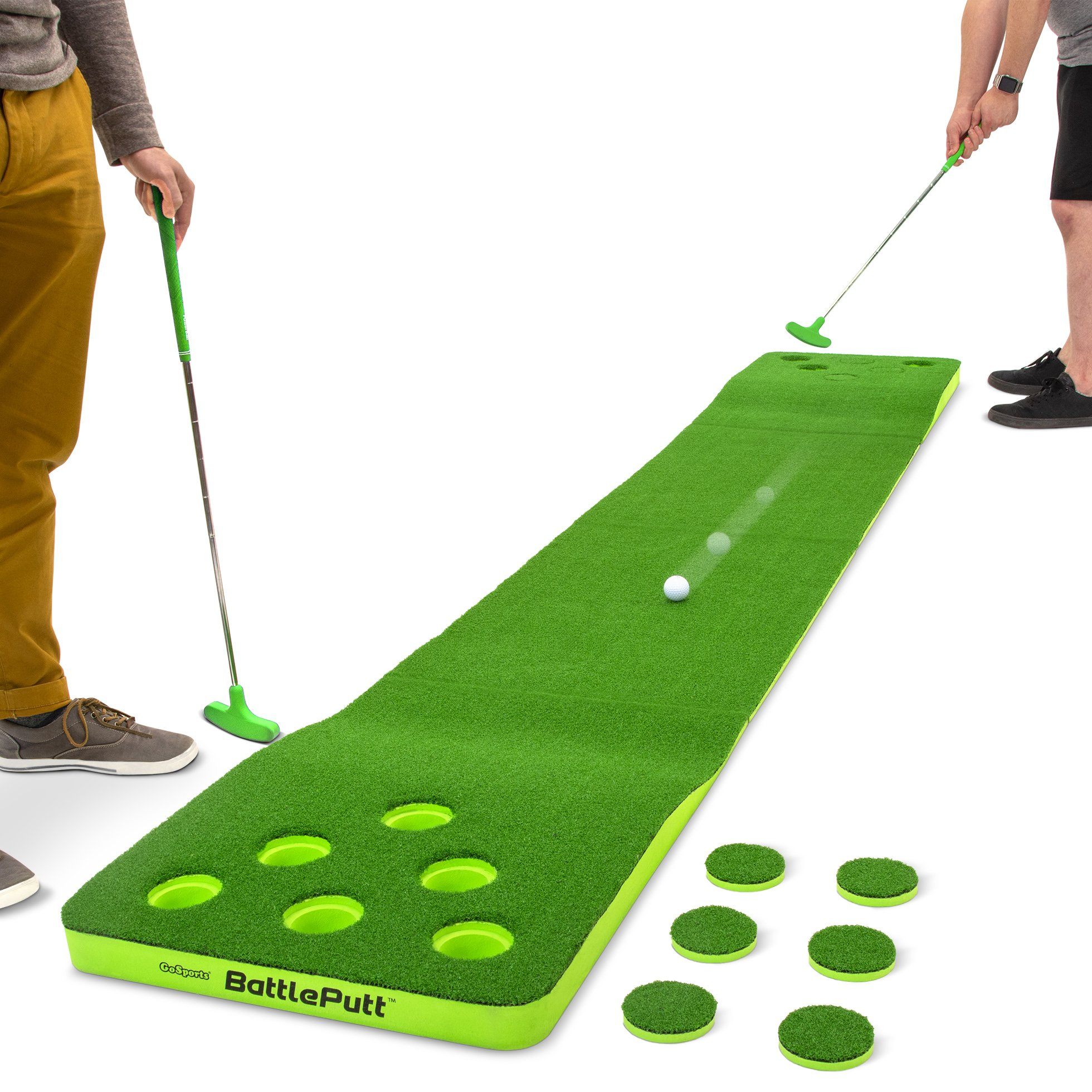 a man putting a golf ball on a putting mat