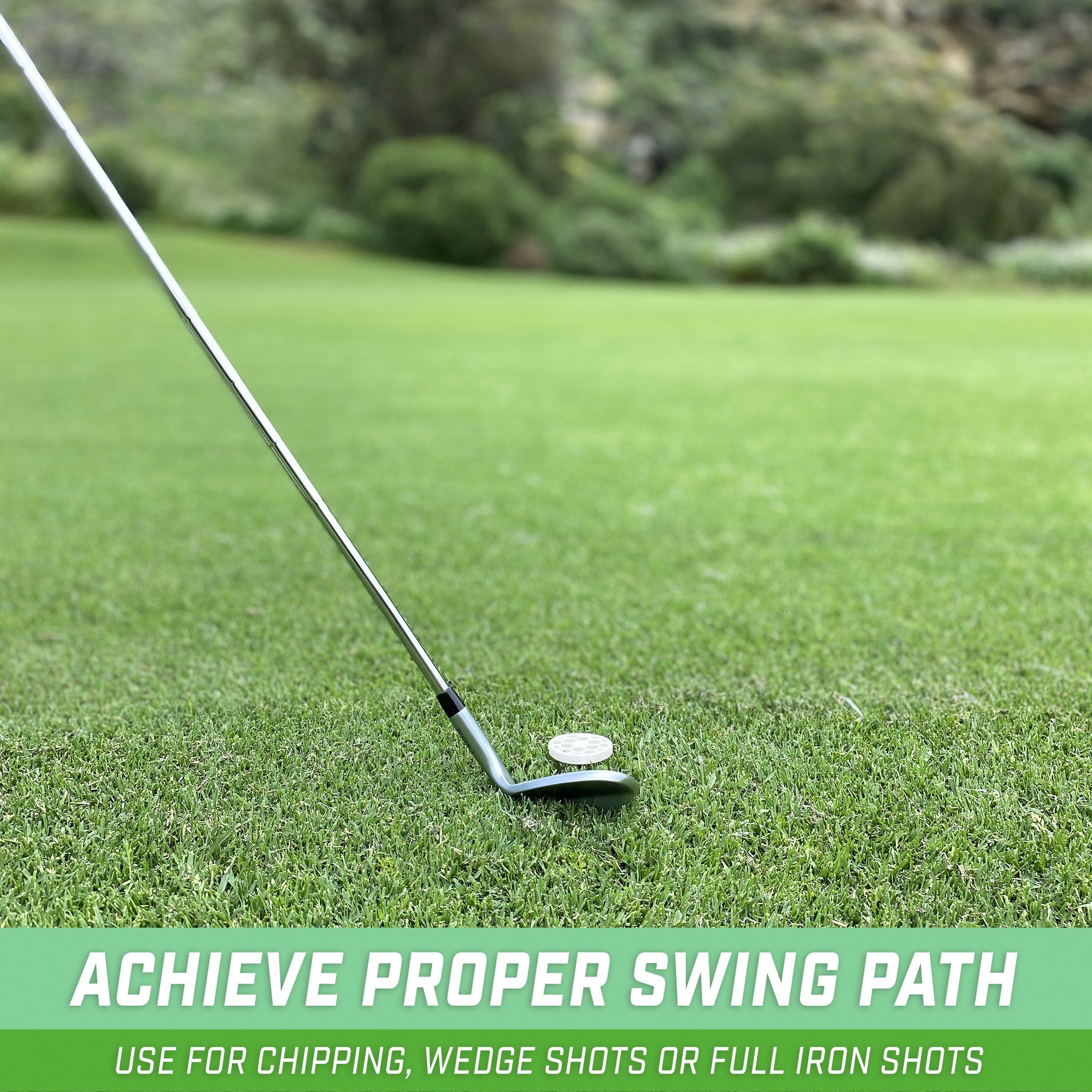 a golf ball and a golf club on the grass