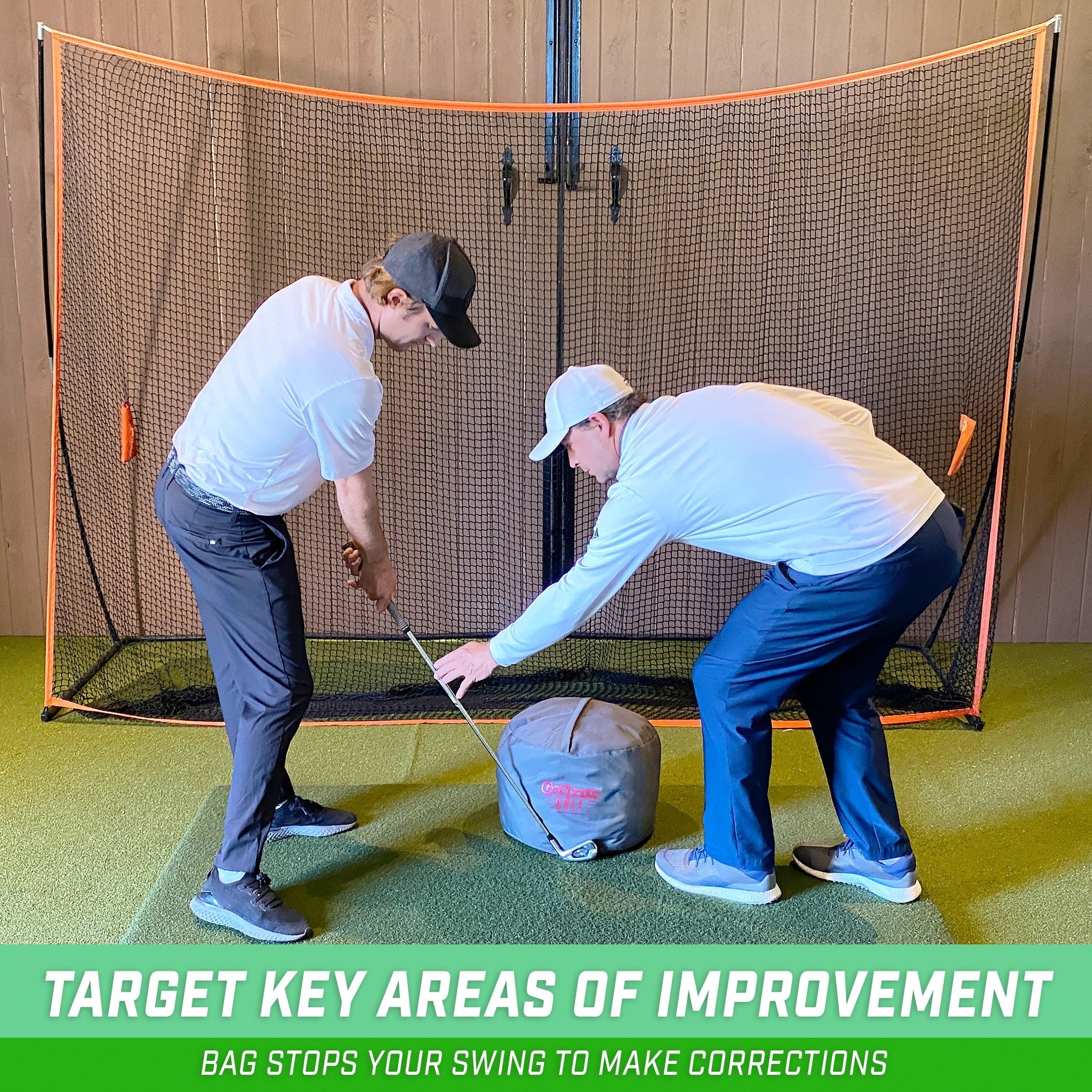 two men playing golf in a golf net