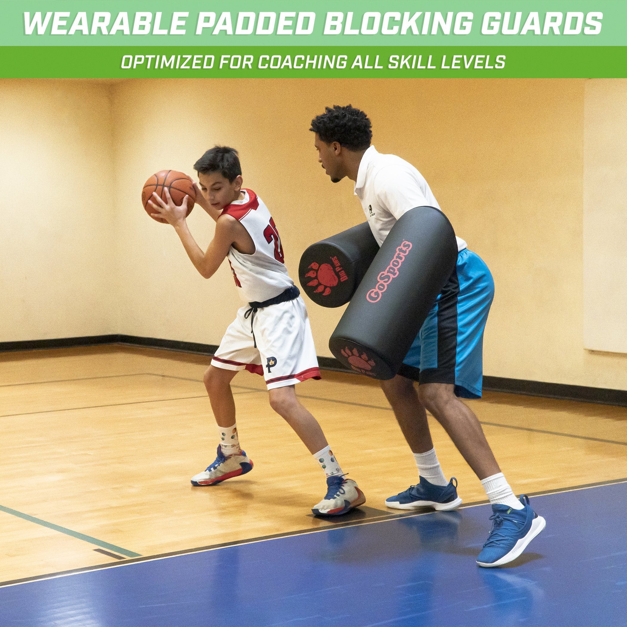 a man holding a basketball ball while another man holds a ball