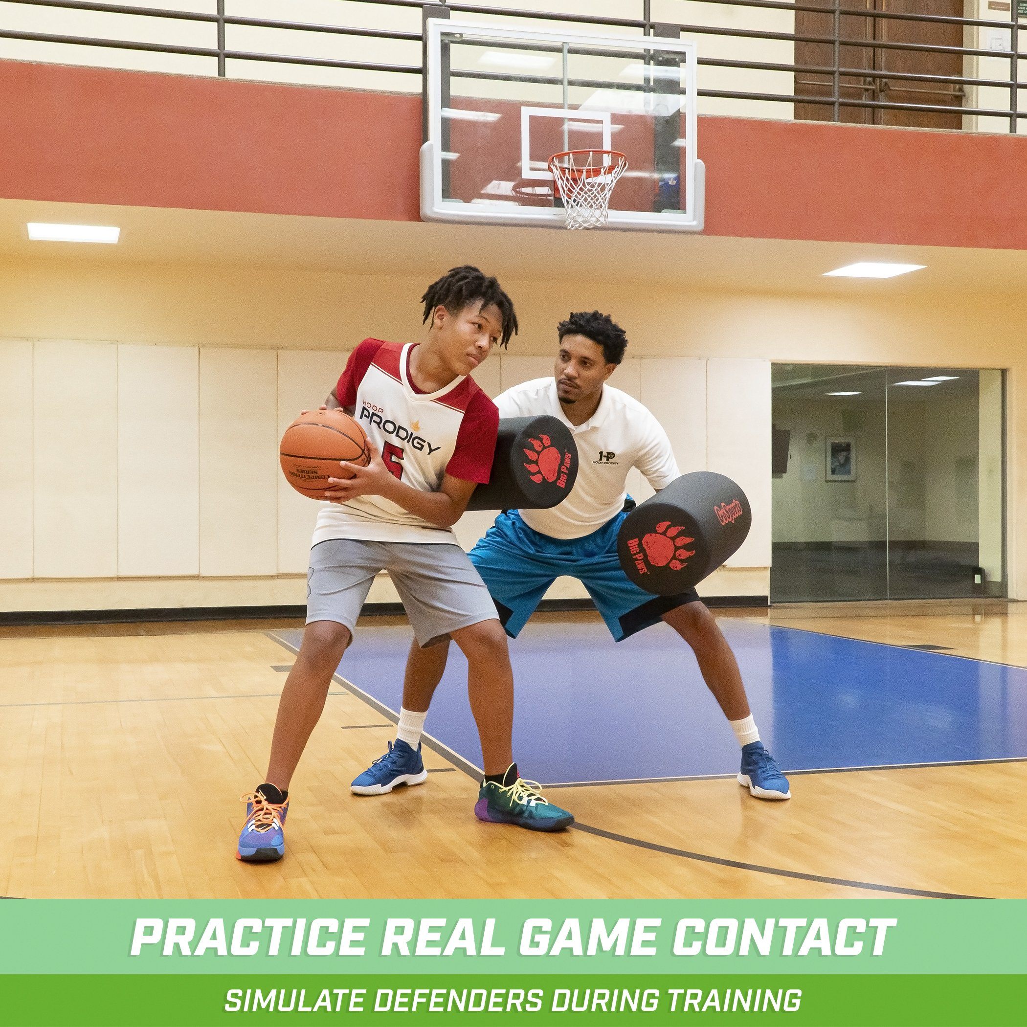 two men playing basketball in a gym