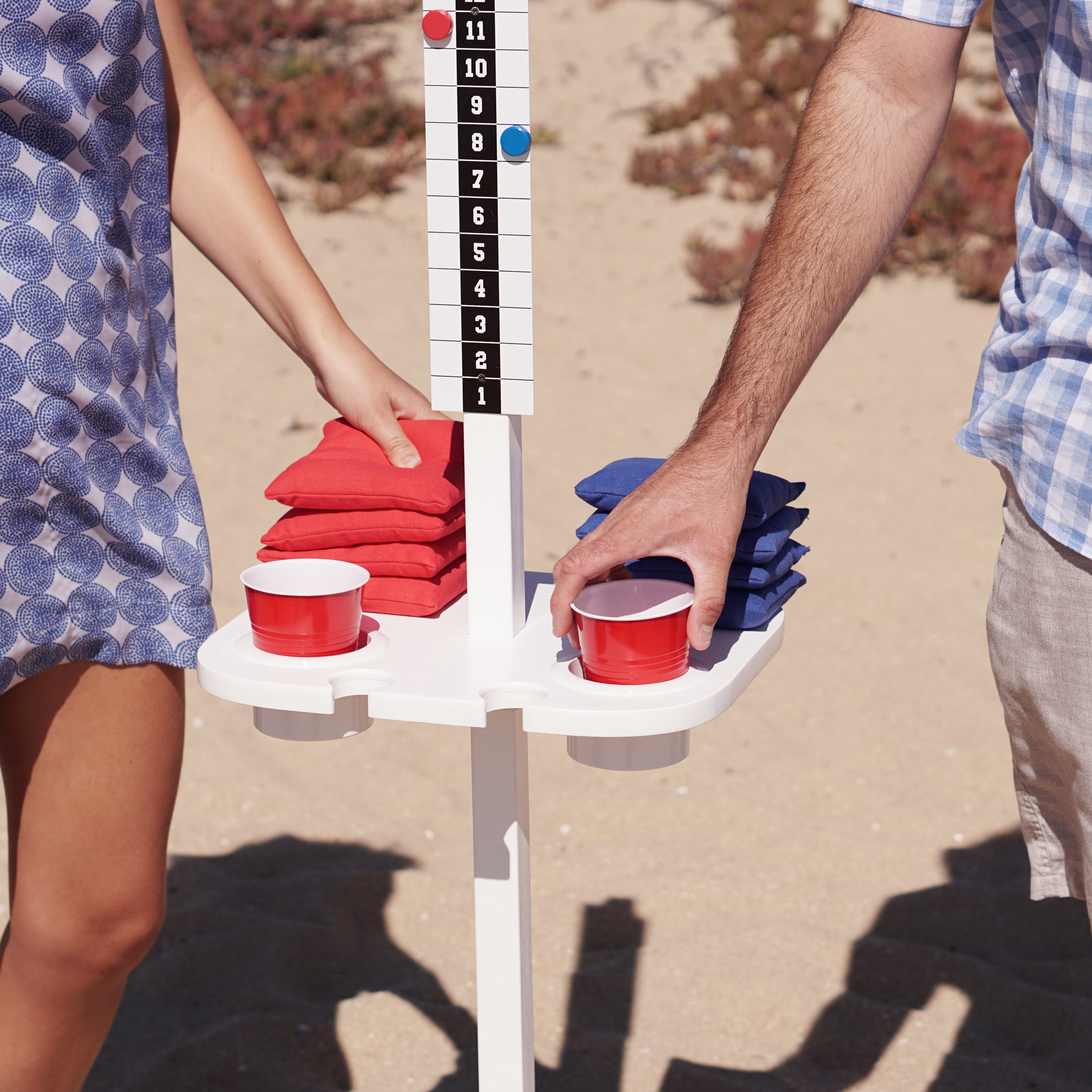 a man and woman holding a pair of red and blue shoes