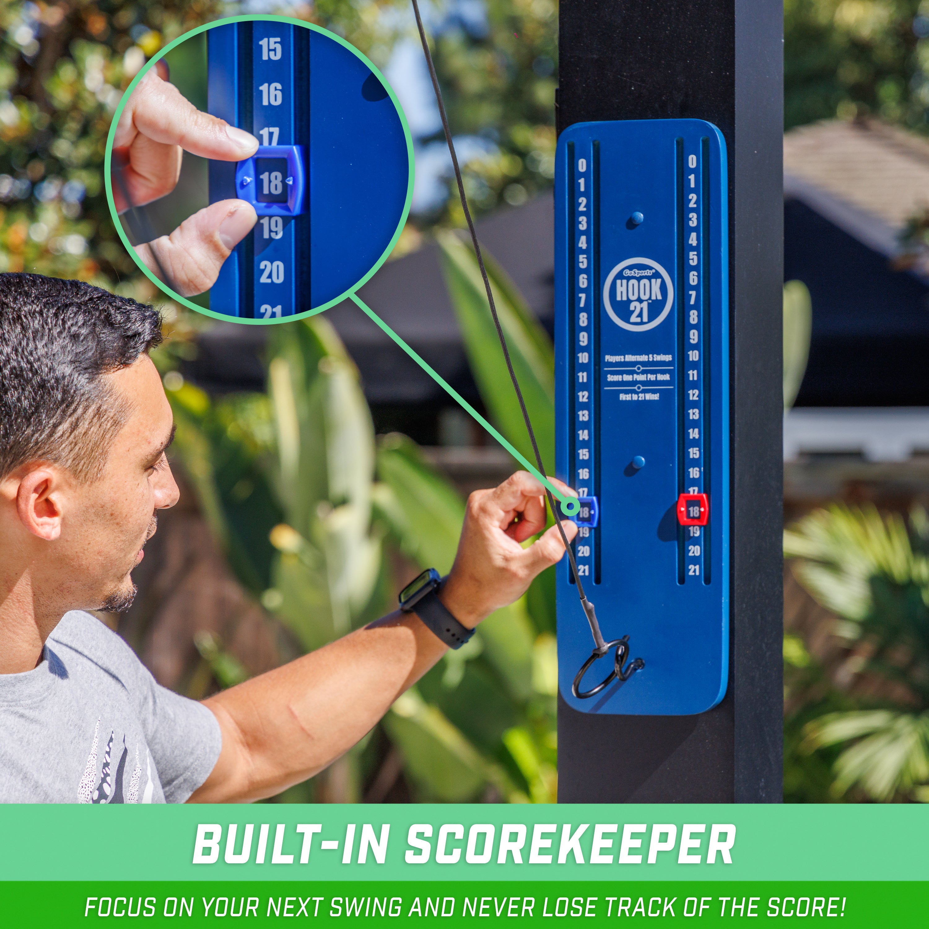 a man is holding a blue device with a green circle