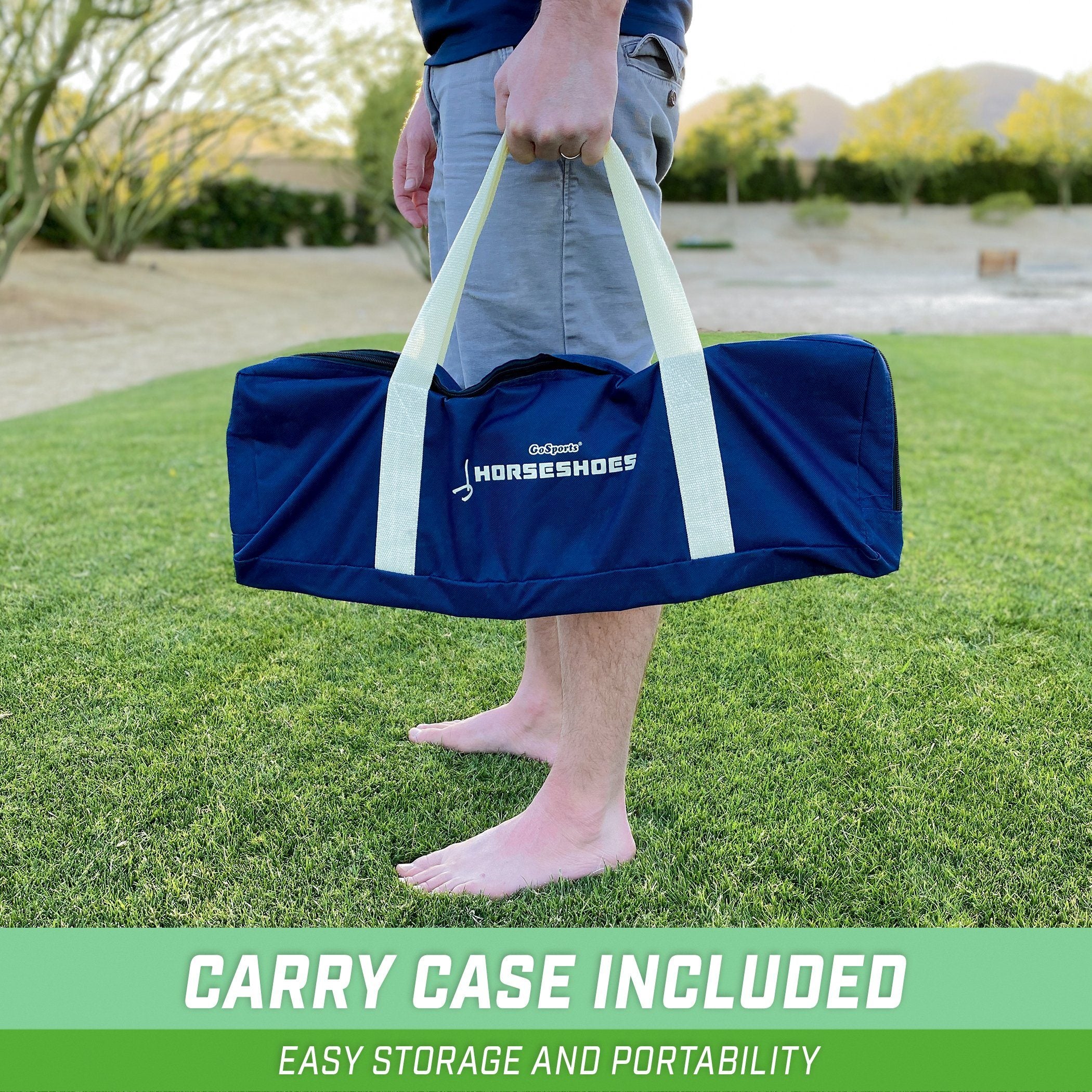 a man carrying a large blue bag on a green lawn