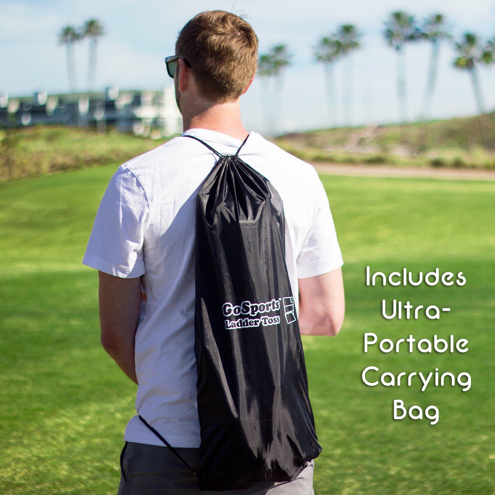 a man carrying a bag of luggage on a field