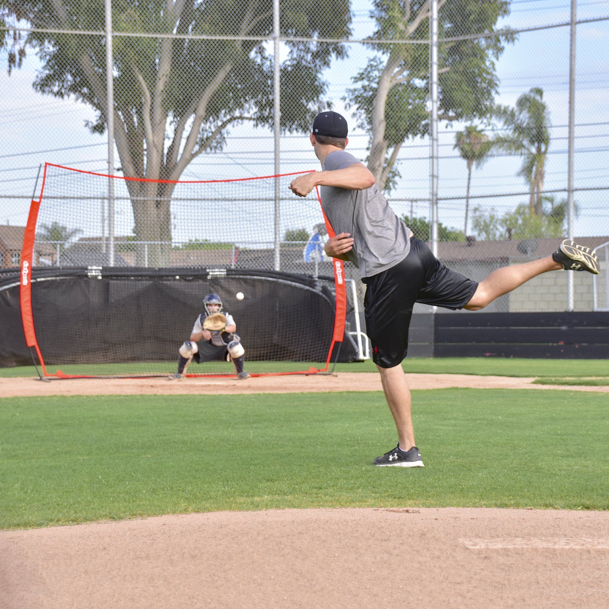 a man is throwing a baseball on a field