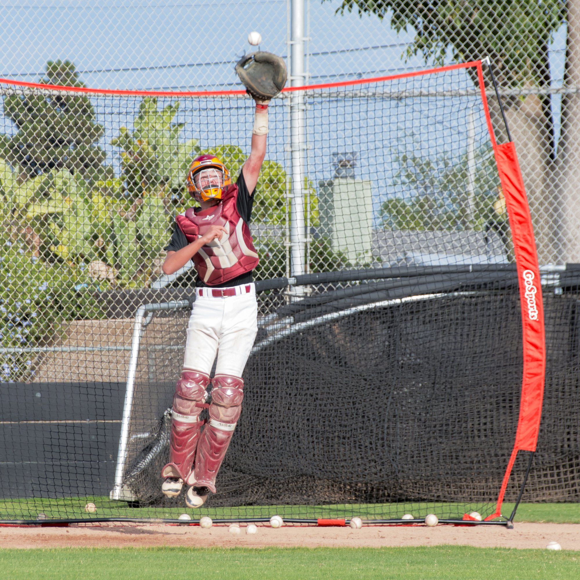 a baseball player is swinging at a ball