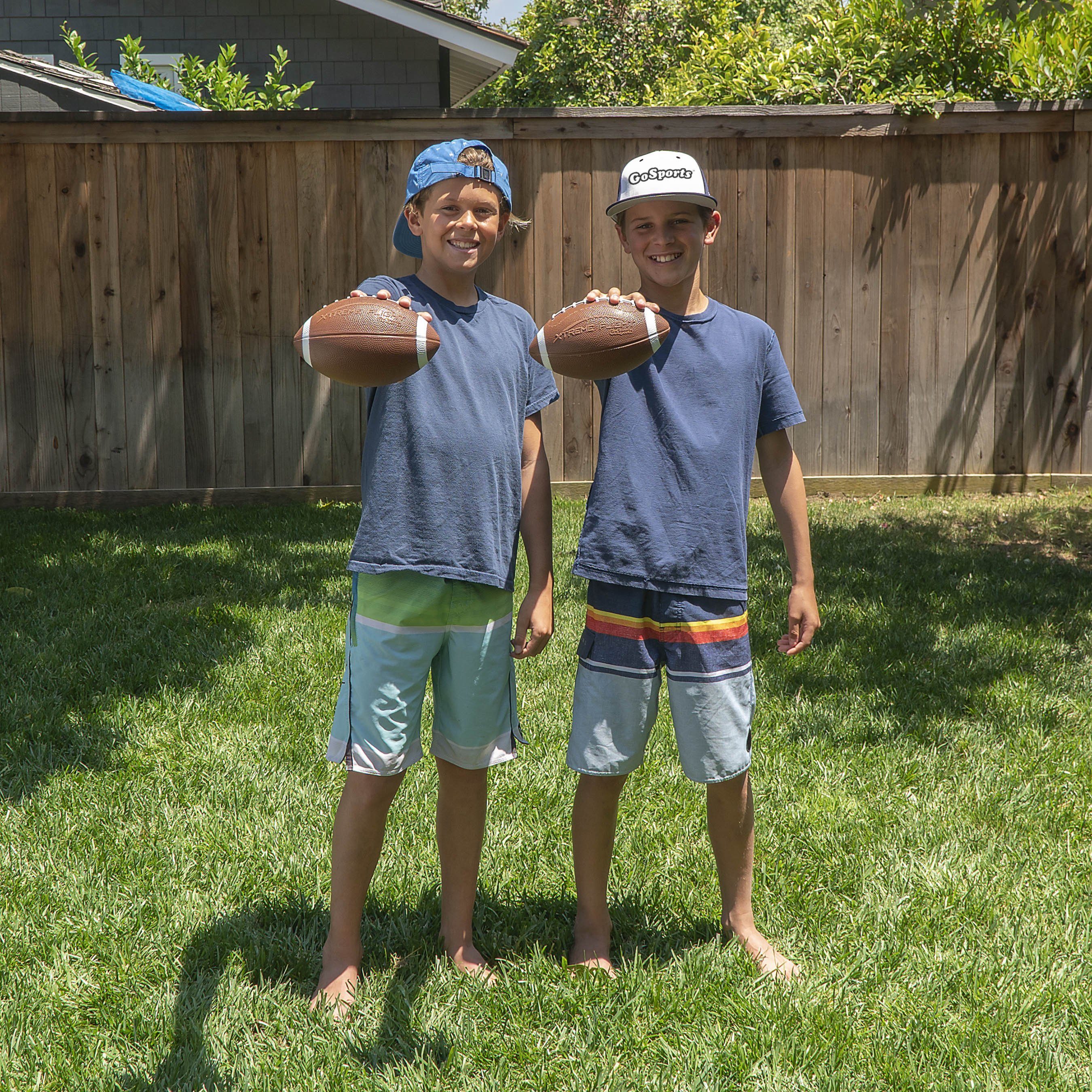 two boys standing in the grass