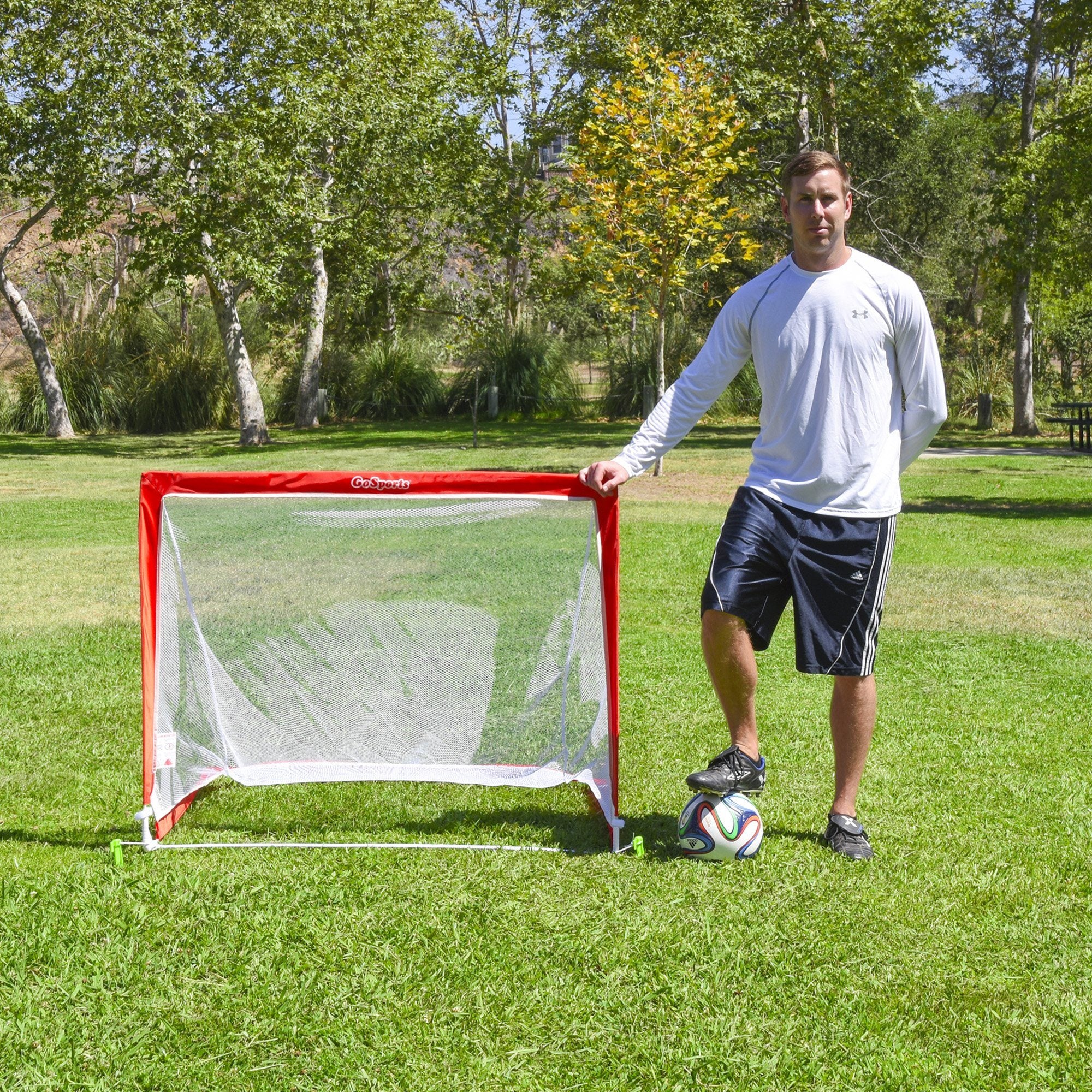 a man standing in a field with a soccer net