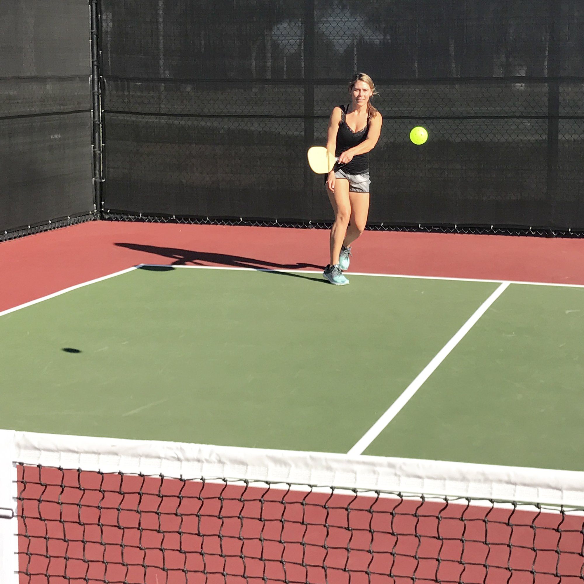 a woman is playing tennis on a court