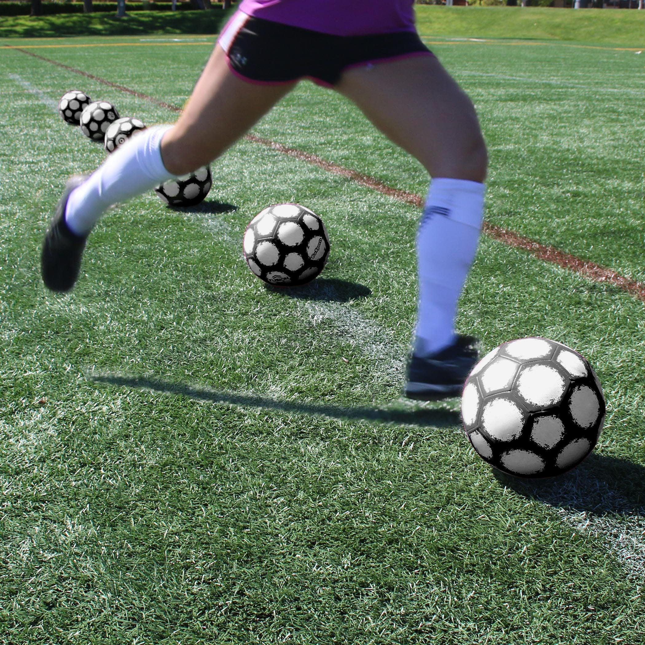 a person kicking a soccer ball on a field