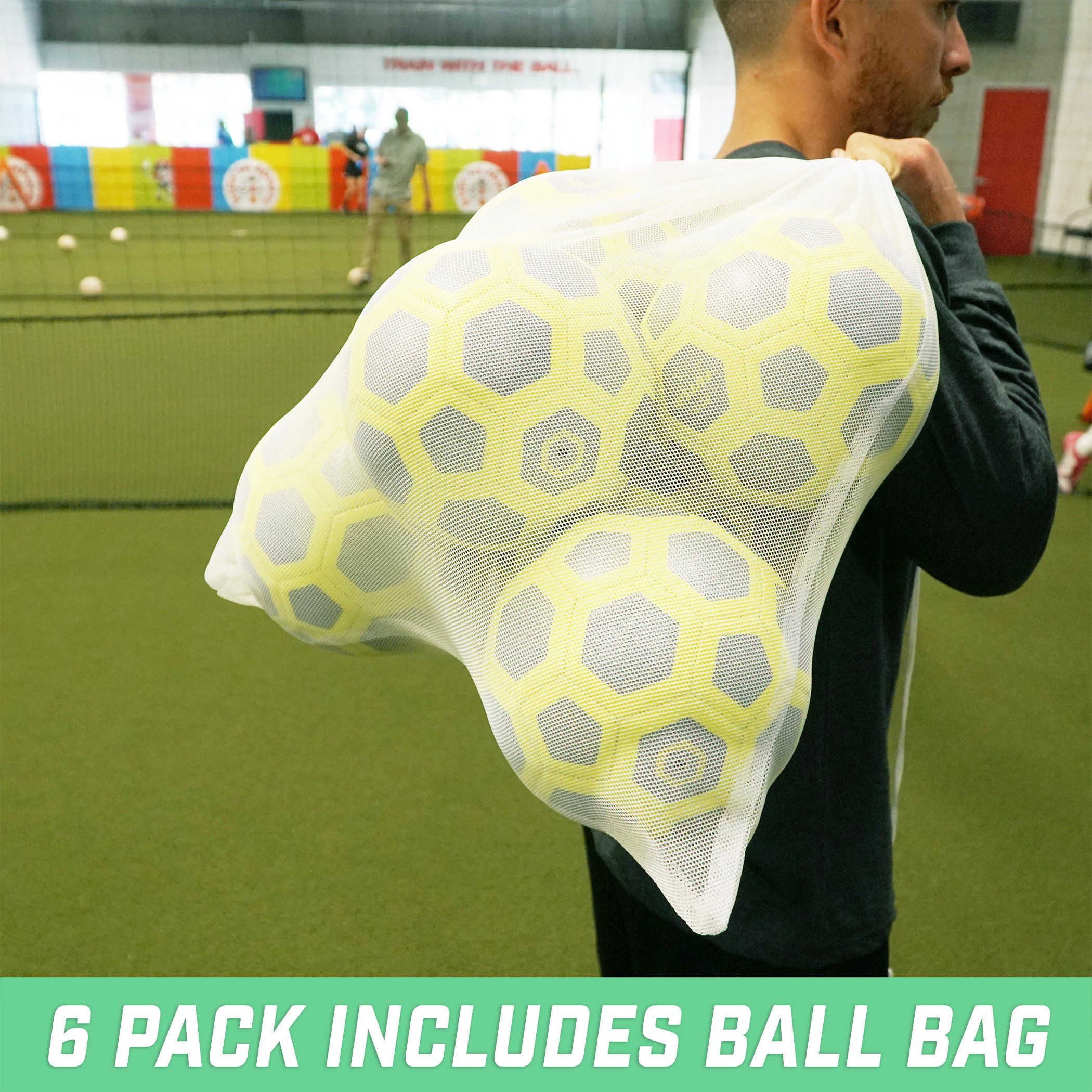 a man holding a bag of balls in a tennis court