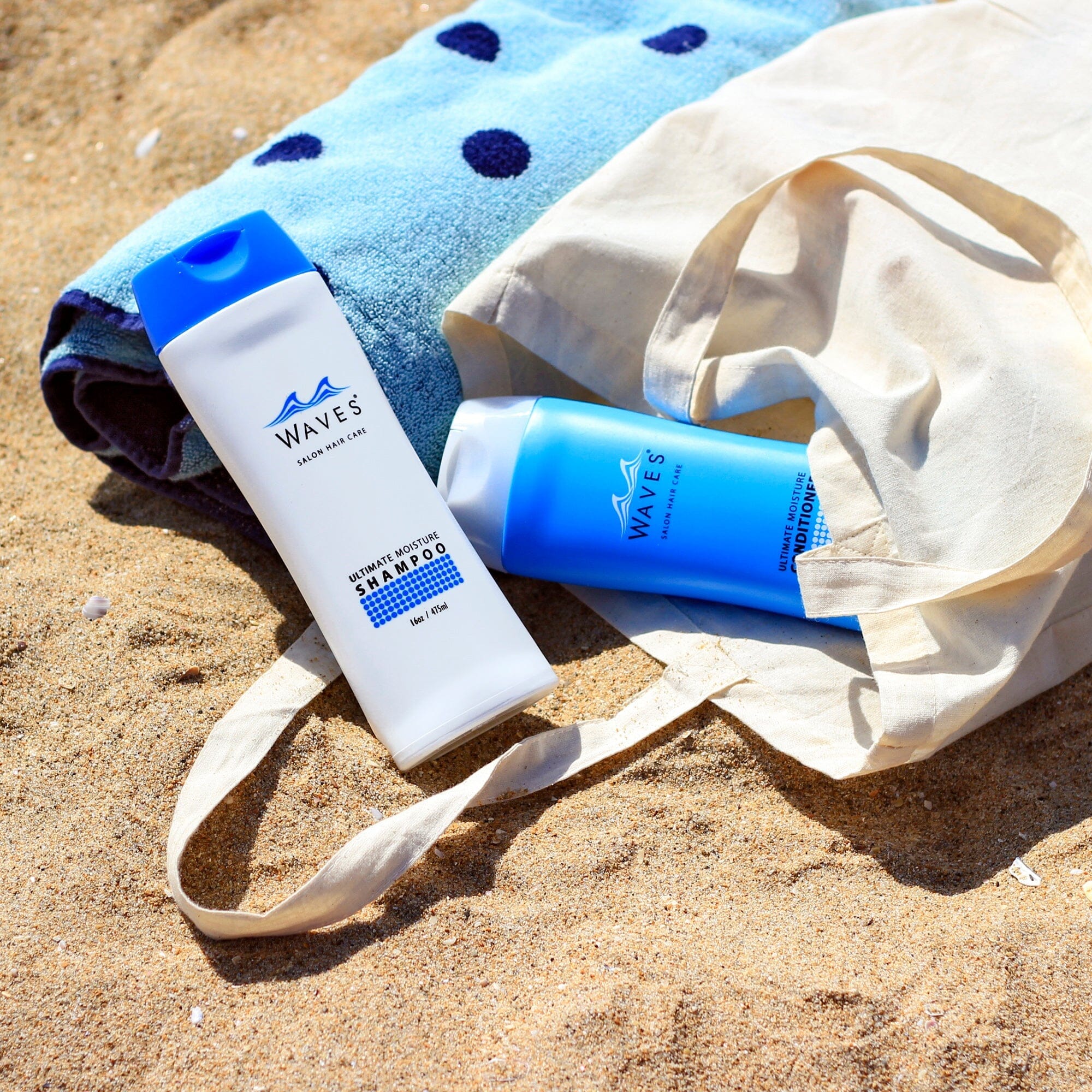 a bottle of sunscreene and a towel on the beach