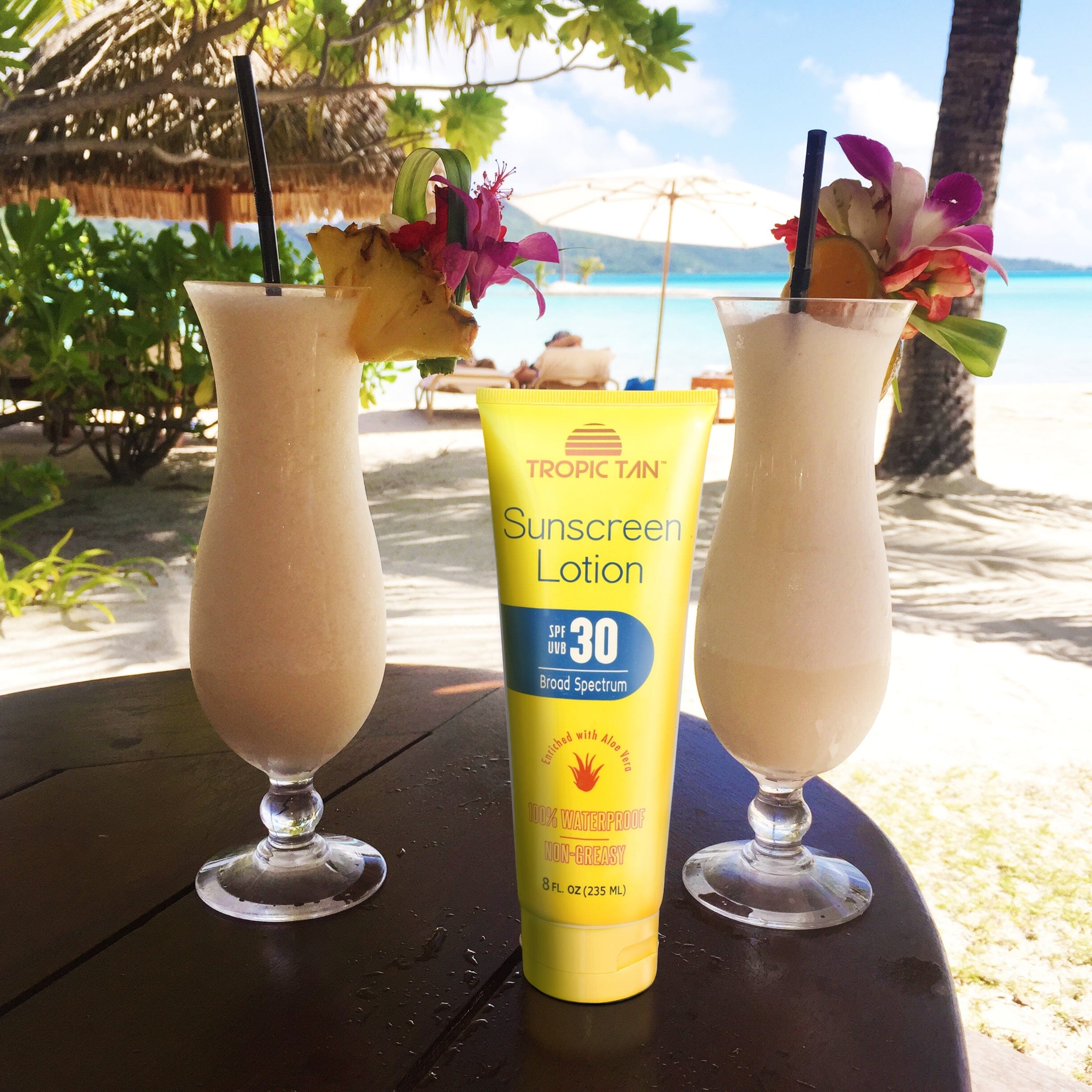 two glasses of sun lotion on a table