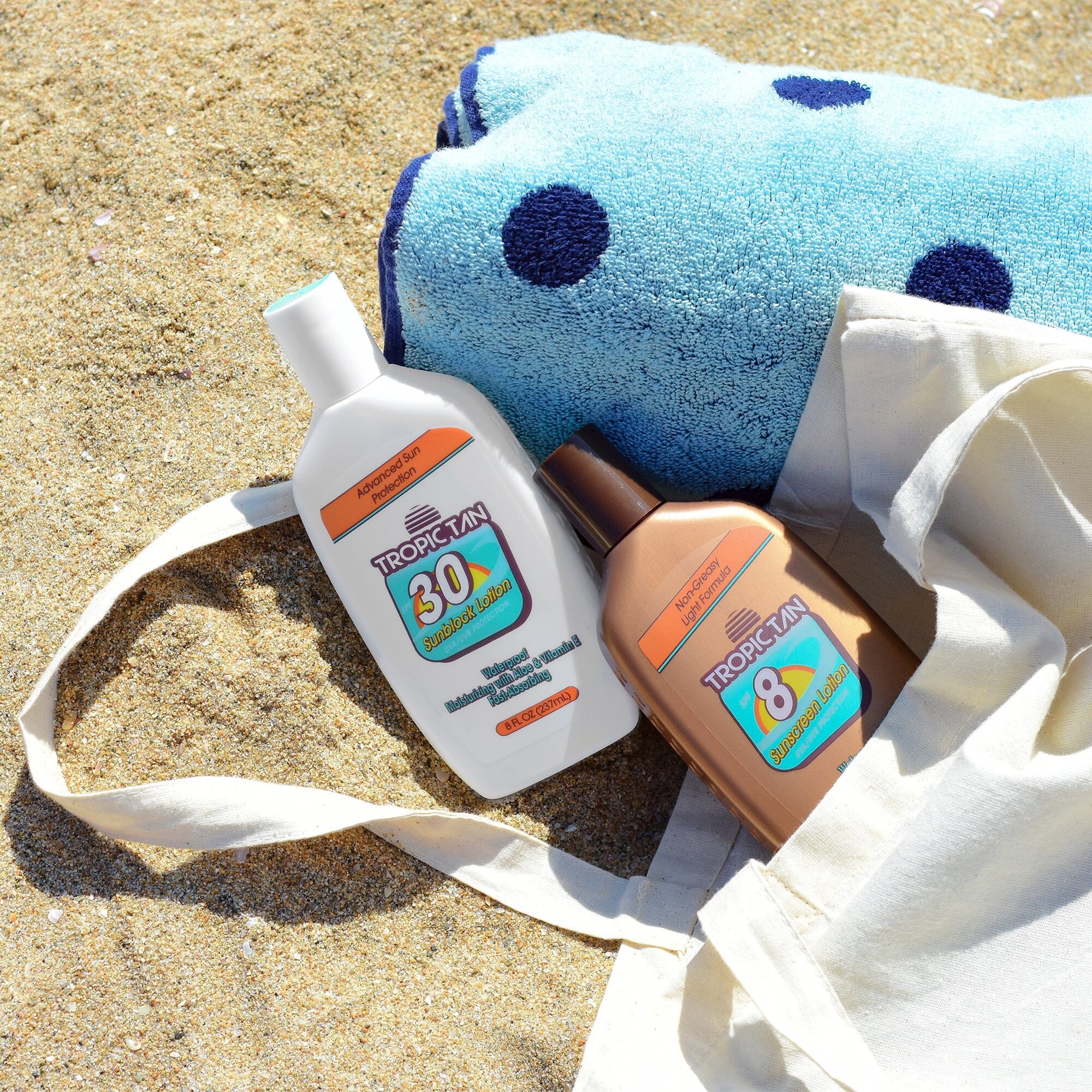 a towel, sunscreener, and sunscreener on the beach