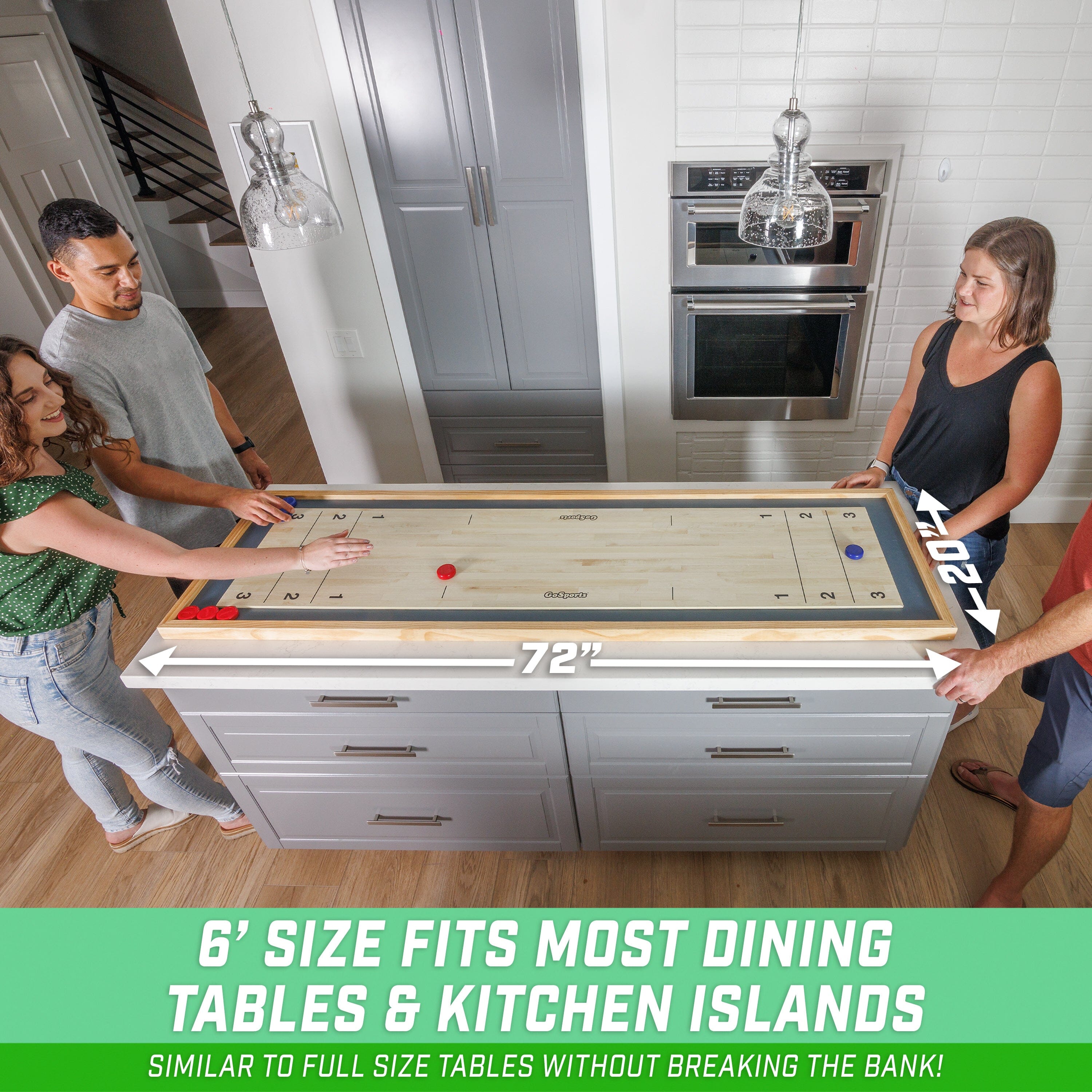 a couple of people standing around a kitchen island