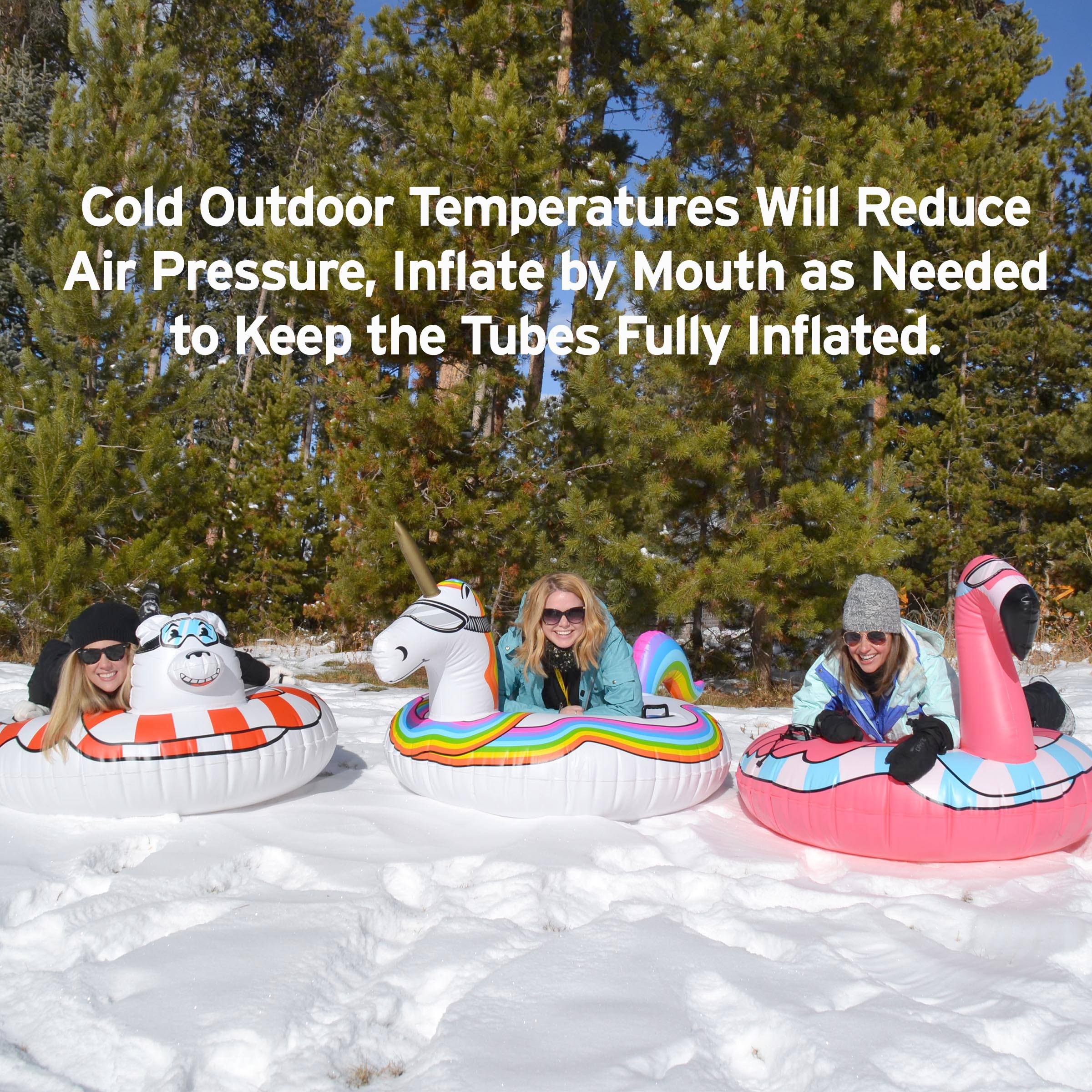 three girls in inflatables in the snow