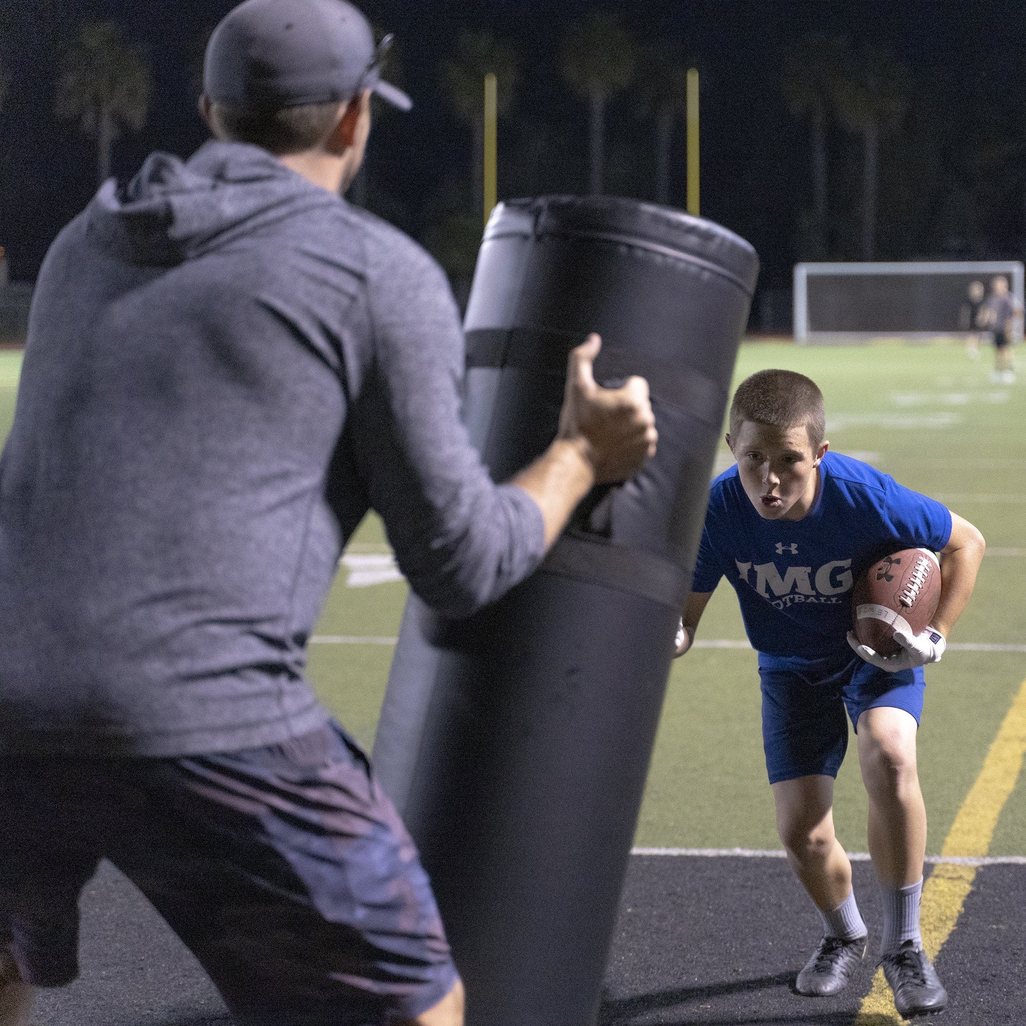 a man holding a football ball and a man holding a football