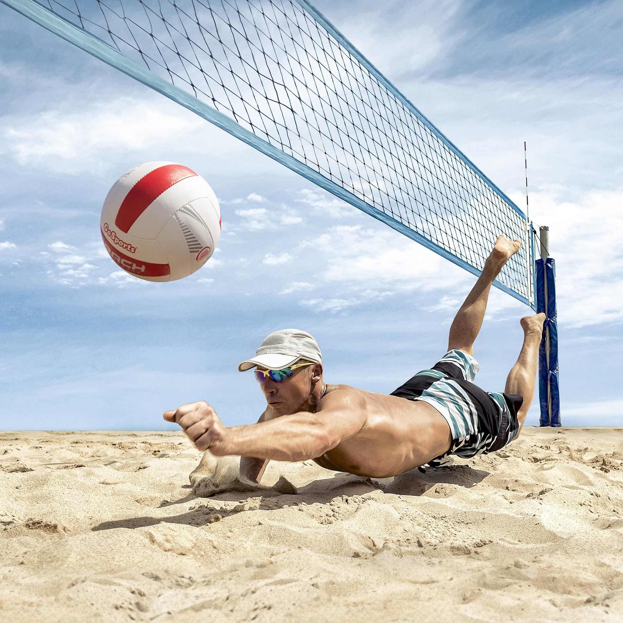 a man laying on the sand