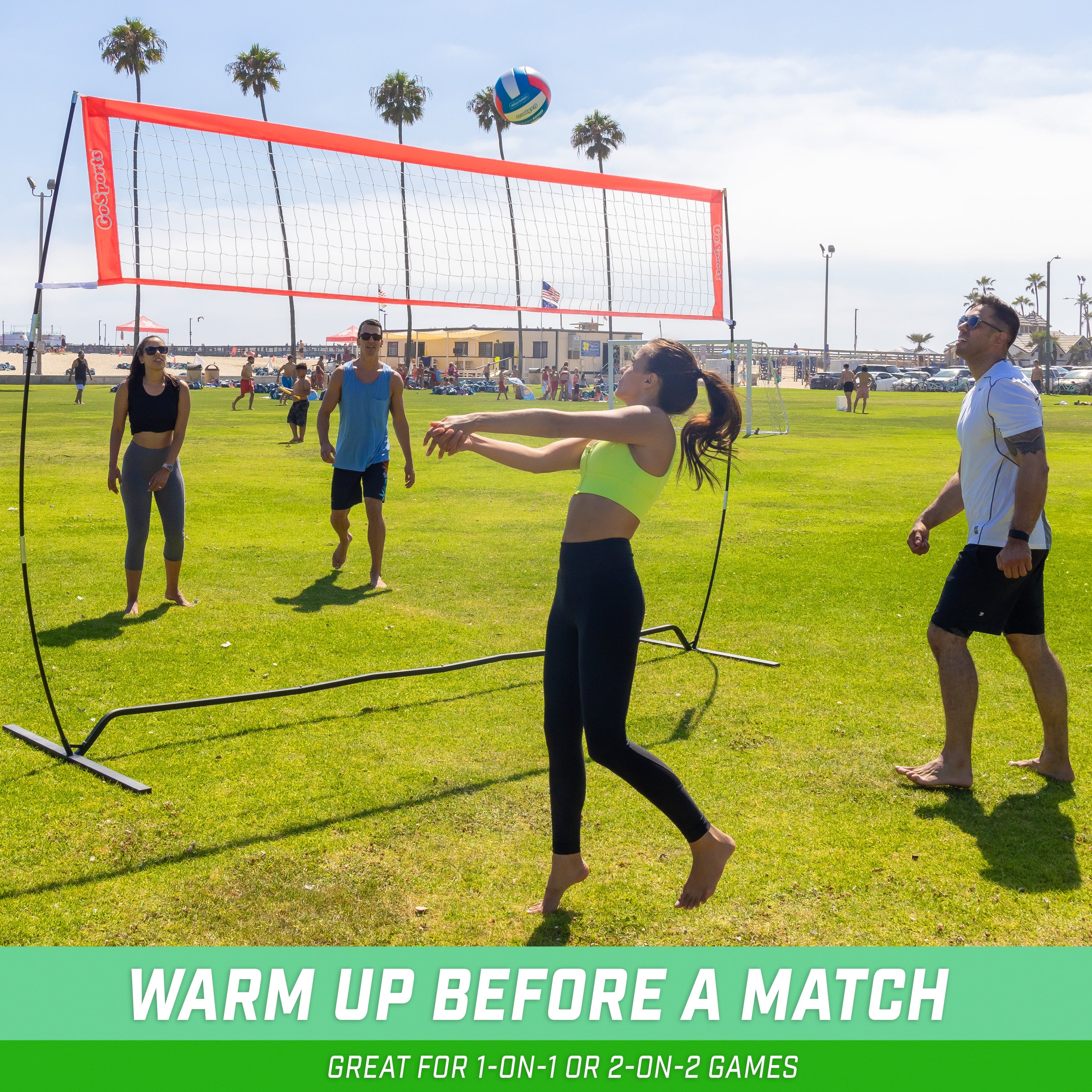 a group of people playing volleyball on a field