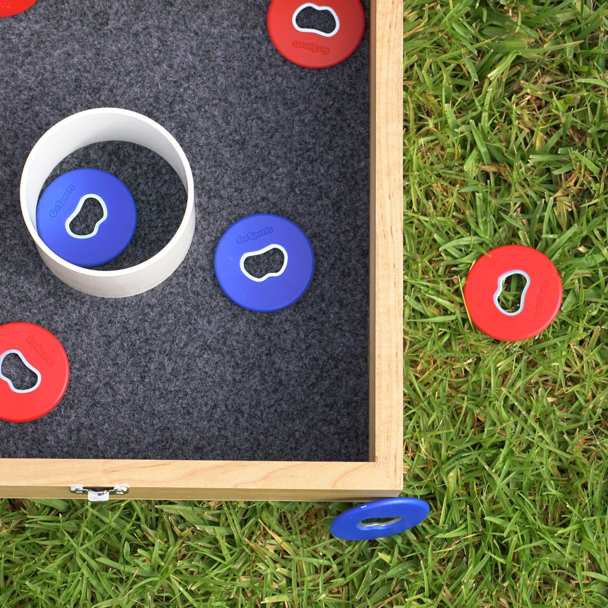 a wooden frame with a game set on the grass
