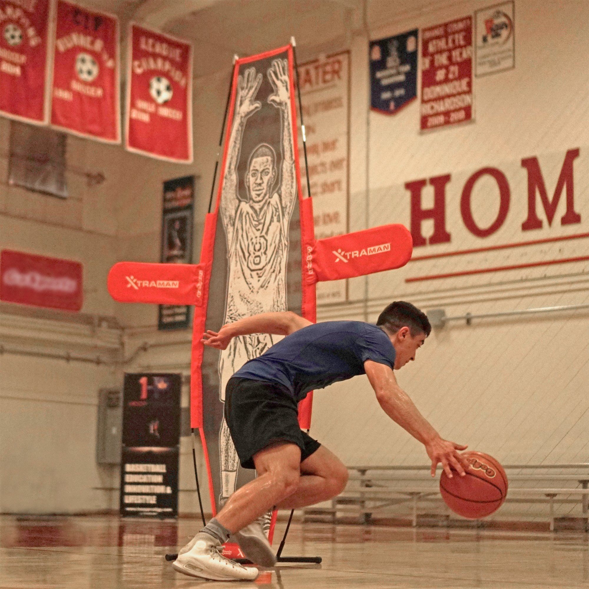 a man is playing basketball in a gym