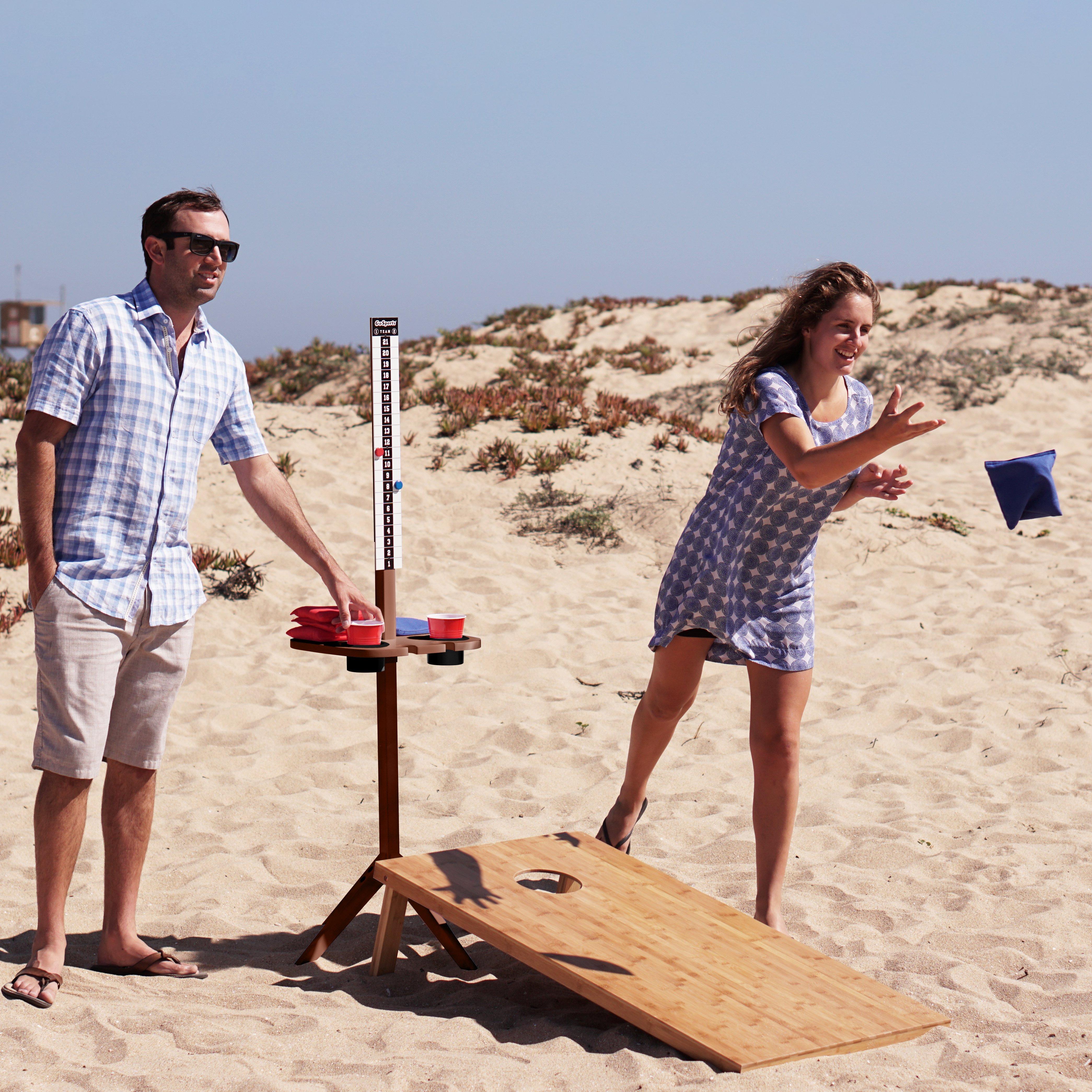 a man and woman playing a game on the beach